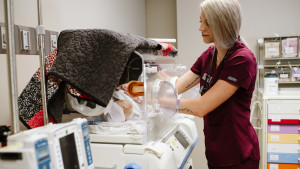 Nursing student working with simulated infant patient